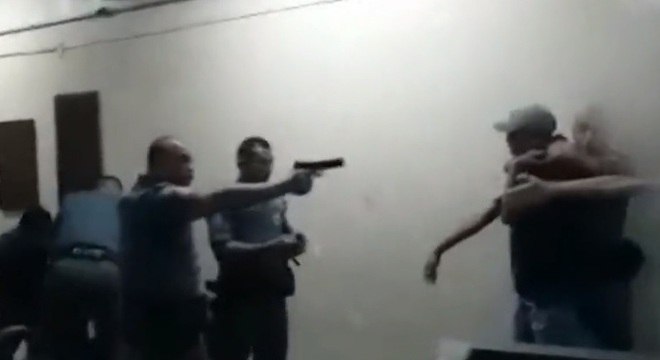 Vídeo mostra policial ao apontar arma para adolescente já imobilizado Reprodução Record TV