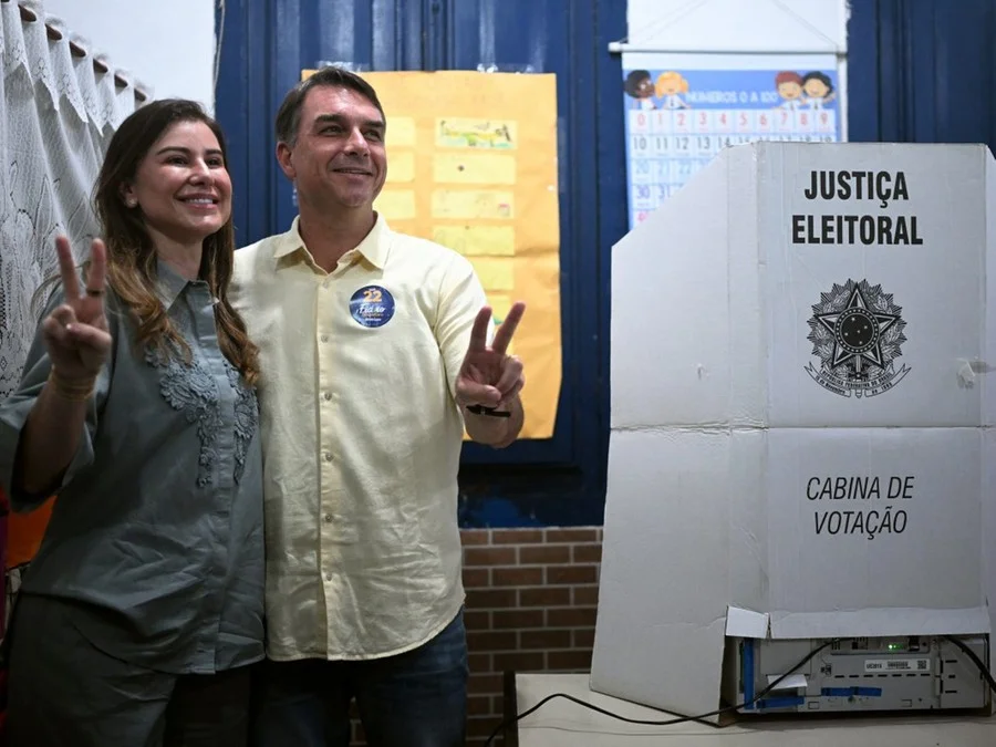O senador de direita e candidato à Presidência pelo Partido Liberal (PL), Flavio Bolsonaro, e sua esposa Fernanda Bolsonaro fazem o gesto de “V” de vitória durante o segundo turno das eleições presidenciais Foto : MAURO PIMENTEL / AFP / CP