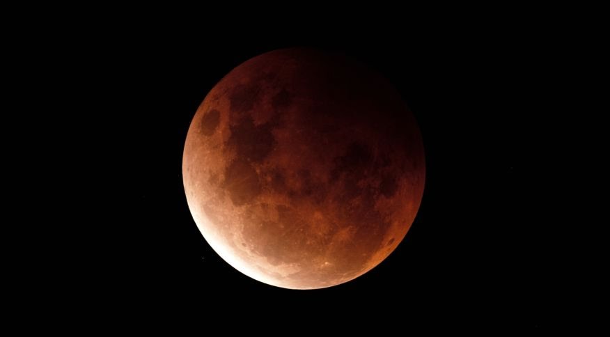 SYDNEY, AUSTRALIA - MAY 26: A super blood moon is seen during a total lunar eclipse on May 26, 2021 in Sydney, Australia. It is the first total lunar eclipse in more than two years, which coincides with a supermoon. A super moon is a name given to a full 